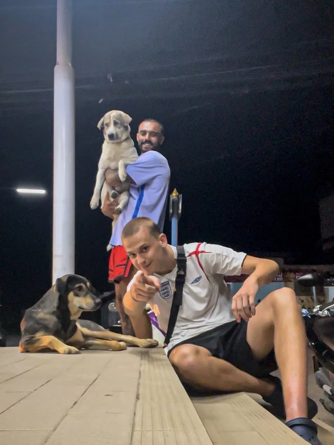 Tom and Ro, founders of The Mission Planet, with rescued street dogs during a night-time rescue mission, highlighting hands-on animal welfare work