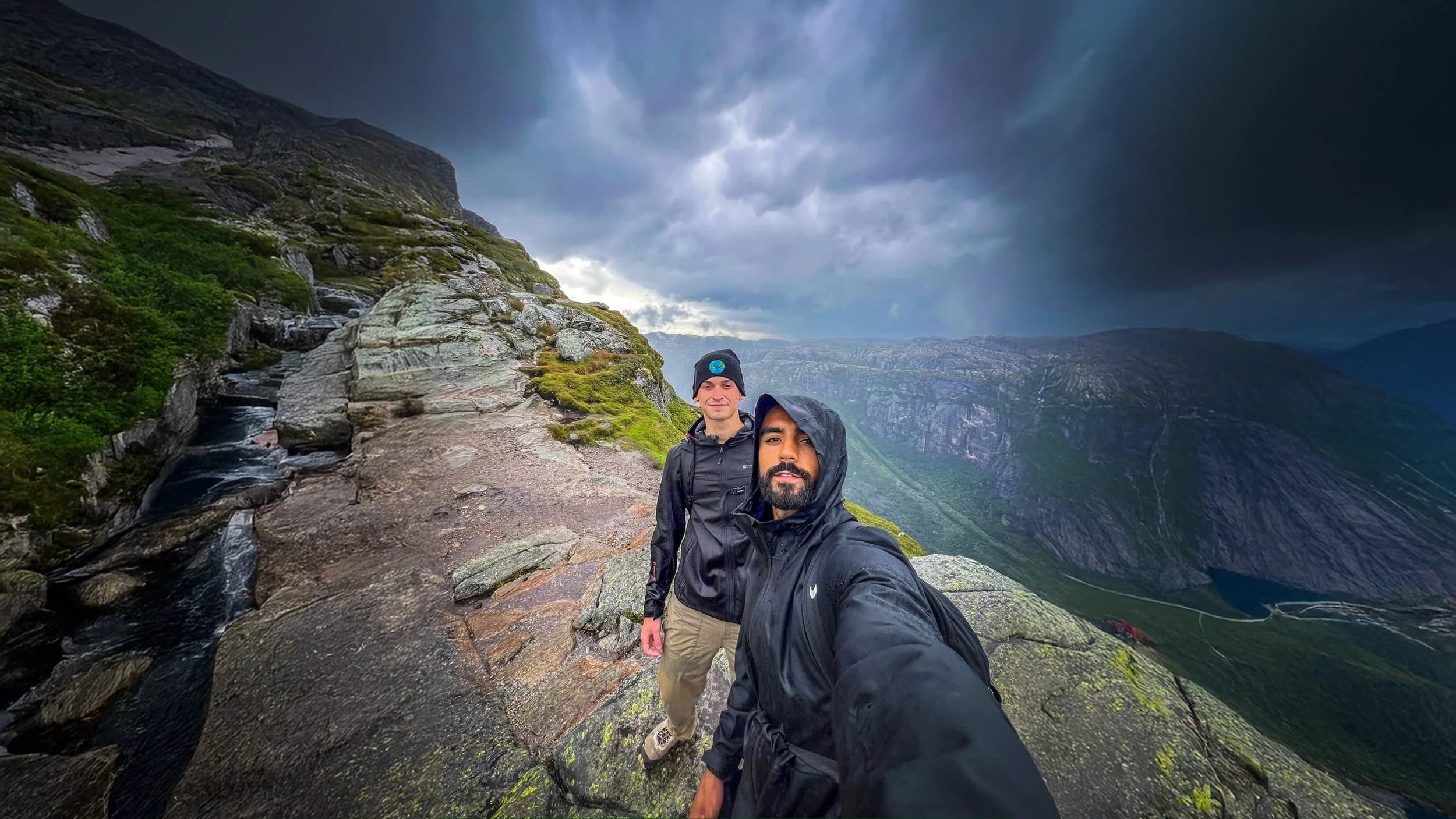 Rohan and Tom hiking through mountainous terrain during challenging conditions as part of a Mission Planet endurance journey