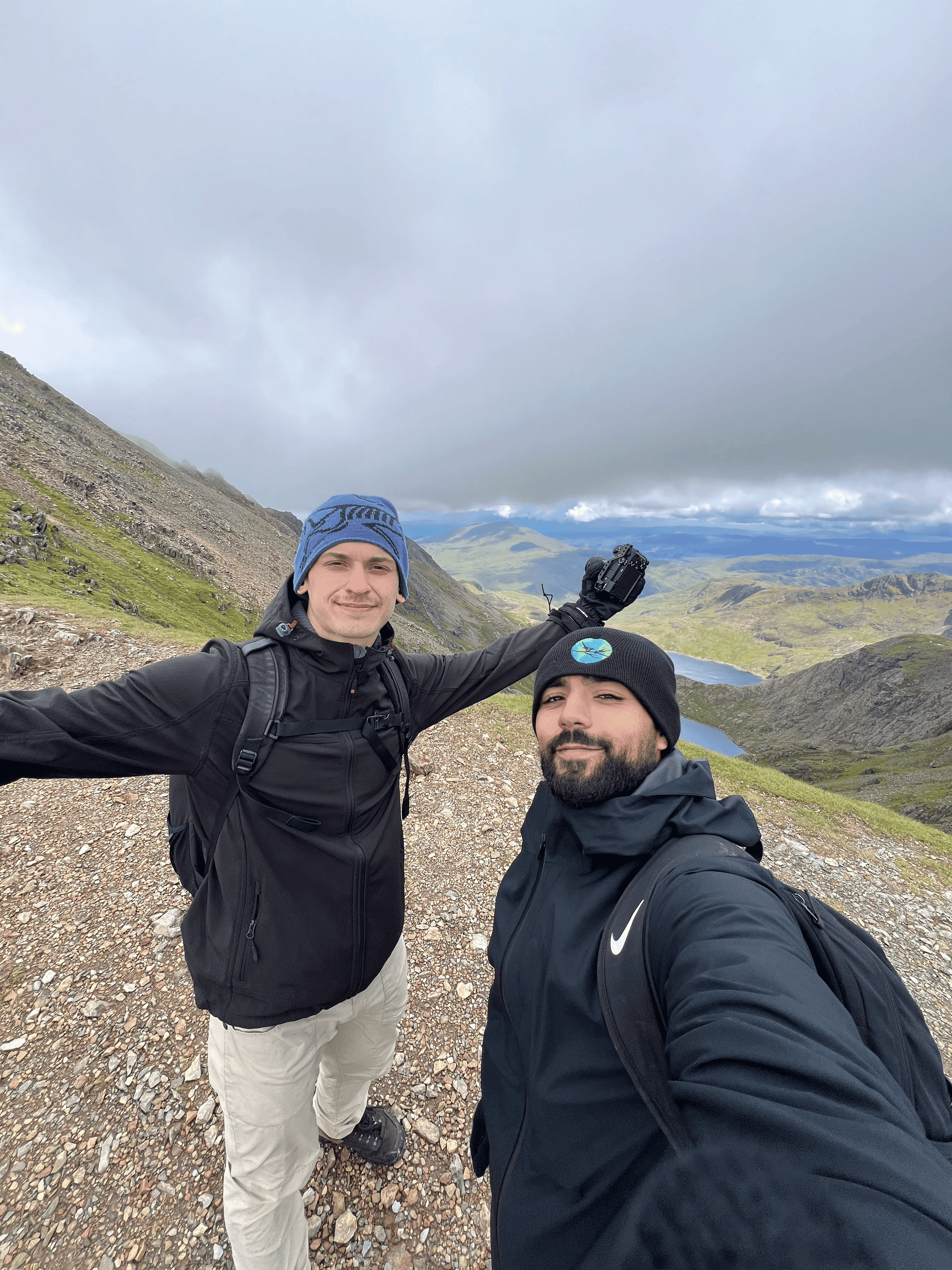Rohan and Tom on a mountain trail during a Mission Planet journey, capturing a moment from an endurance-led mission