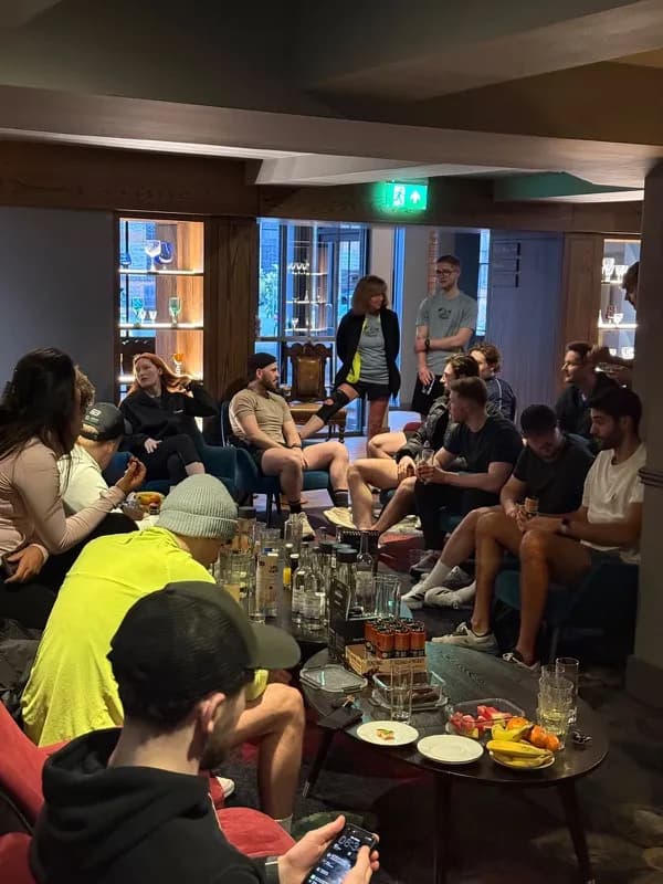 A group sitting together around low tables in the evening
