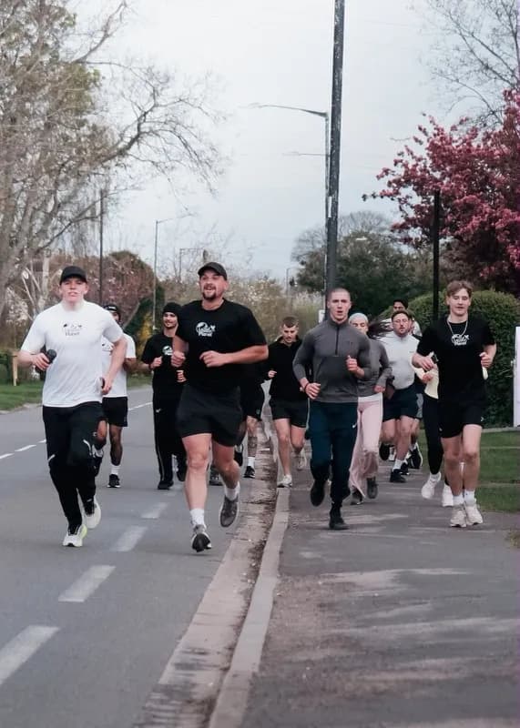 Runners on a road on a grey morning
