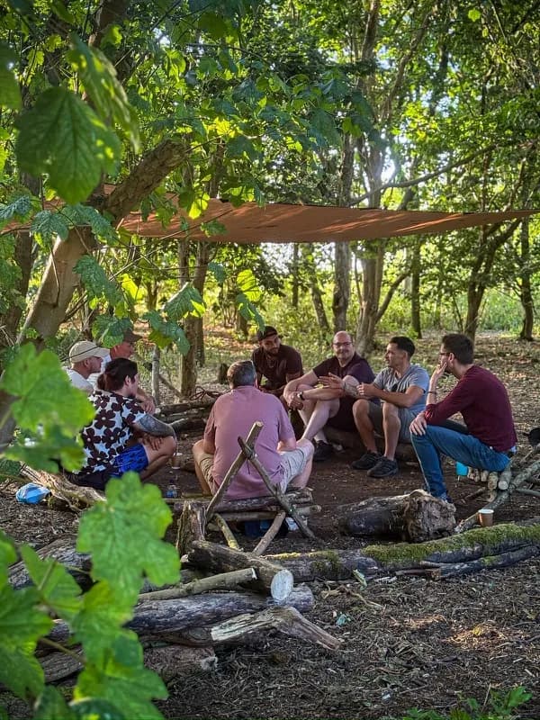 People working together outdoors among trees