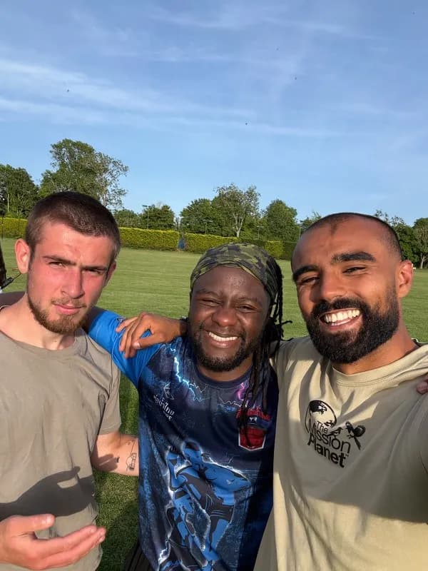 Three people smiling together after training