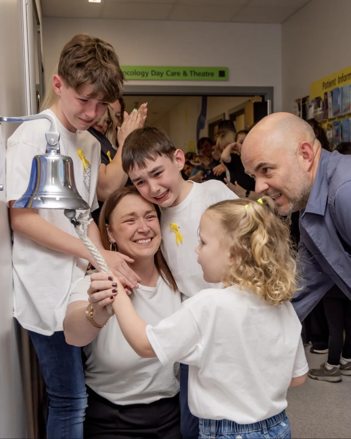 A family ringing the end of treatment bell at Birmingham Children's Hospital