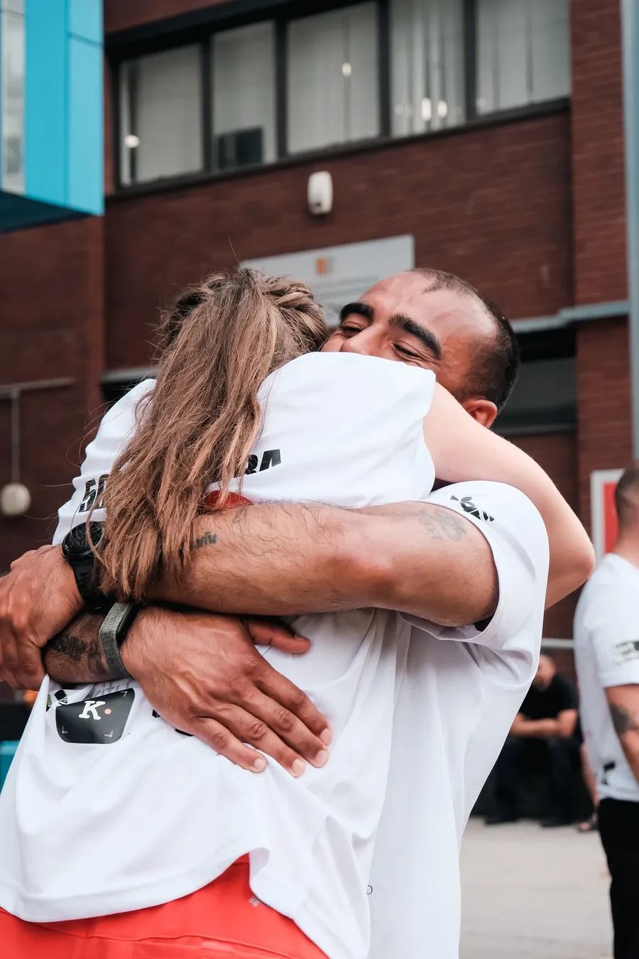 Two of the runners embracing at the finish