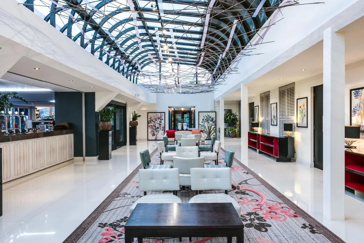 The hotel's atrium lounge and bar, under a glass roof